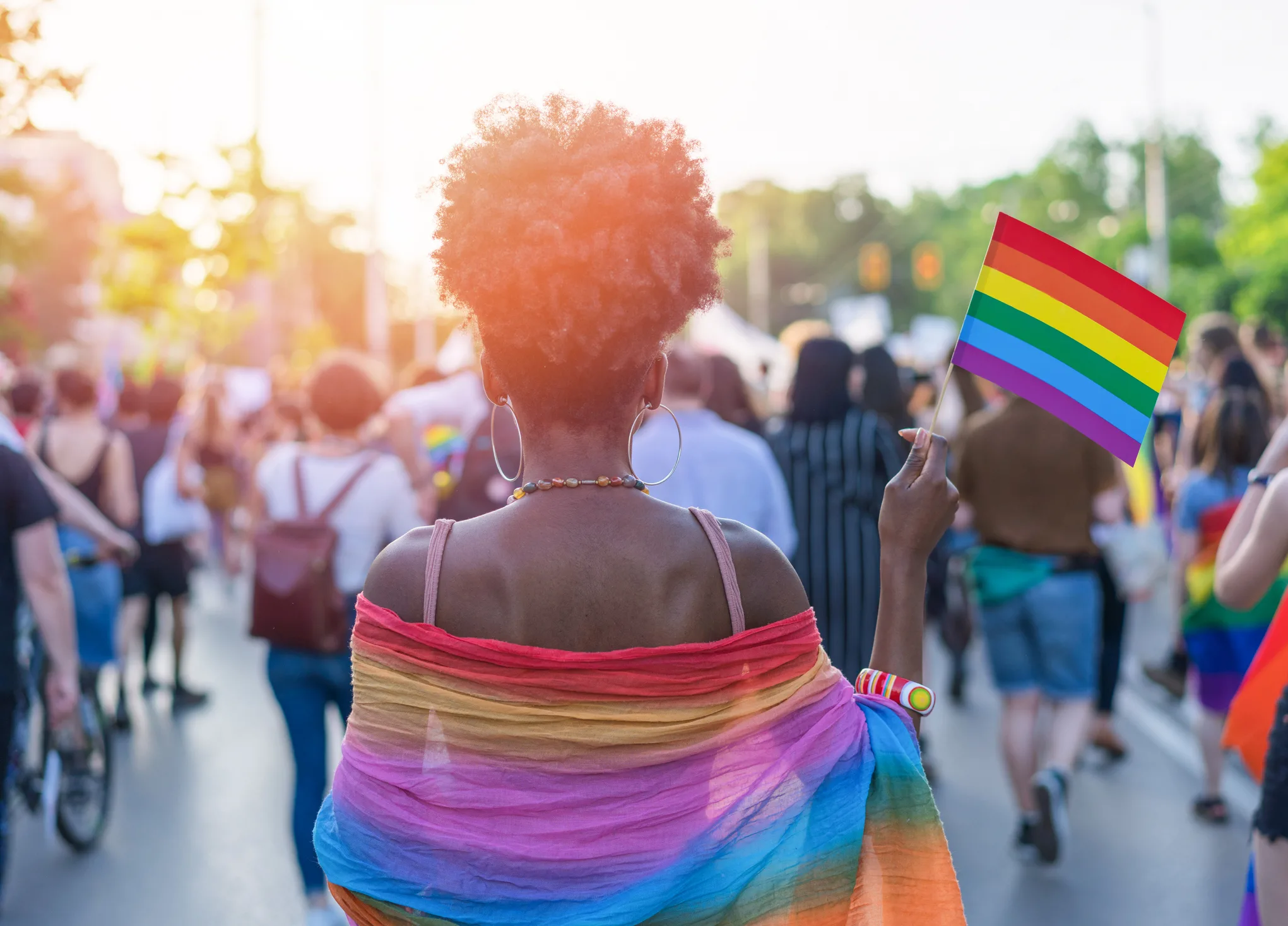 Woman at Tacoma Pride waving pride flag
