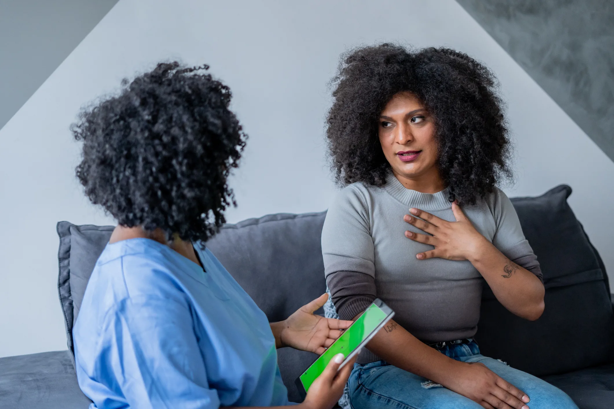A trans woman speaking with a counselor about resource navigation