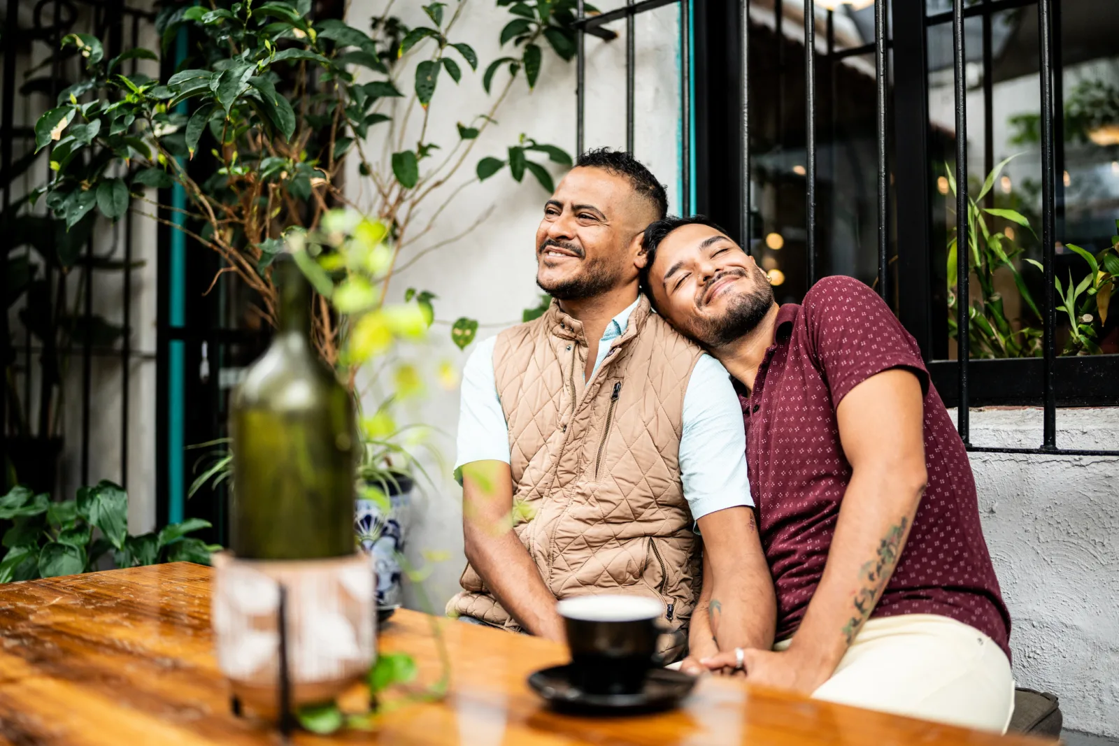 Two gay men on a couch talking about queer wellness