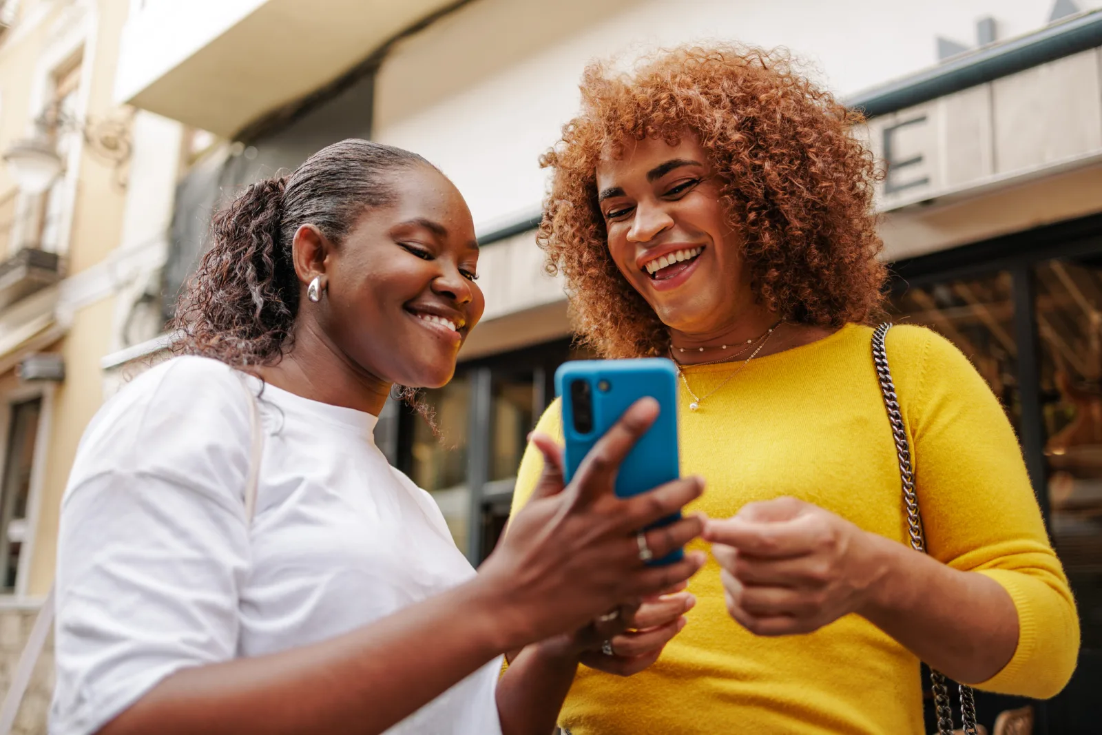 Two women discussing queer advocacy and education